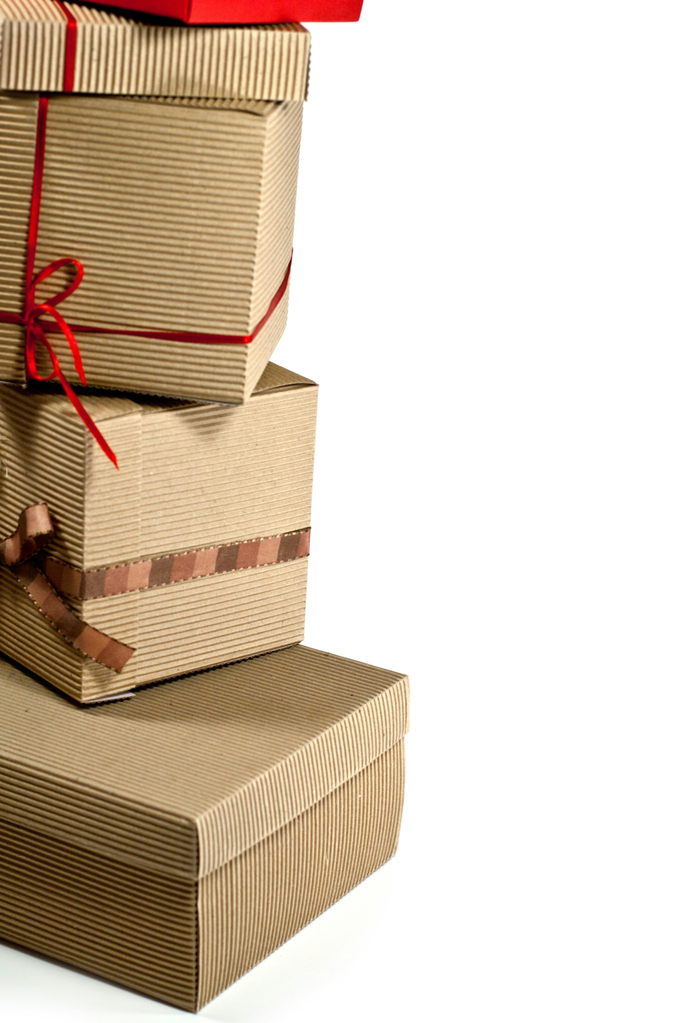 A stack of three boxes wrapped in brown paper