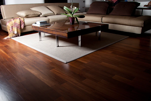 A living room filled with furniture and a wooden floor