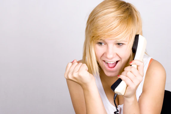 A woman holding a phone up to her ear