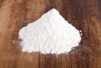 A pile of white powder sitting on top of a wooden table