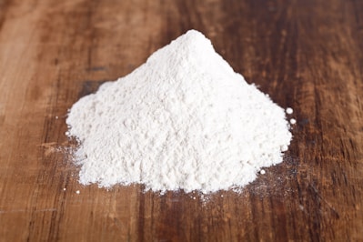 A pile of white powder sitting on top of a wooden table