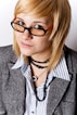 A woman wearing glasses and a necklace