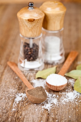 A wooden table topped with salt and pepper shakers