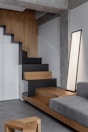 A living room with a couch and stairs