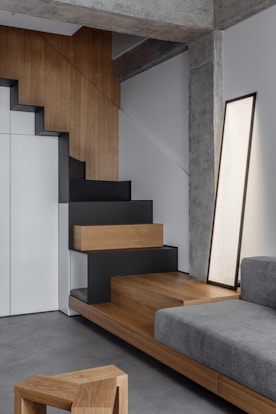 A living room with a couch and stairs