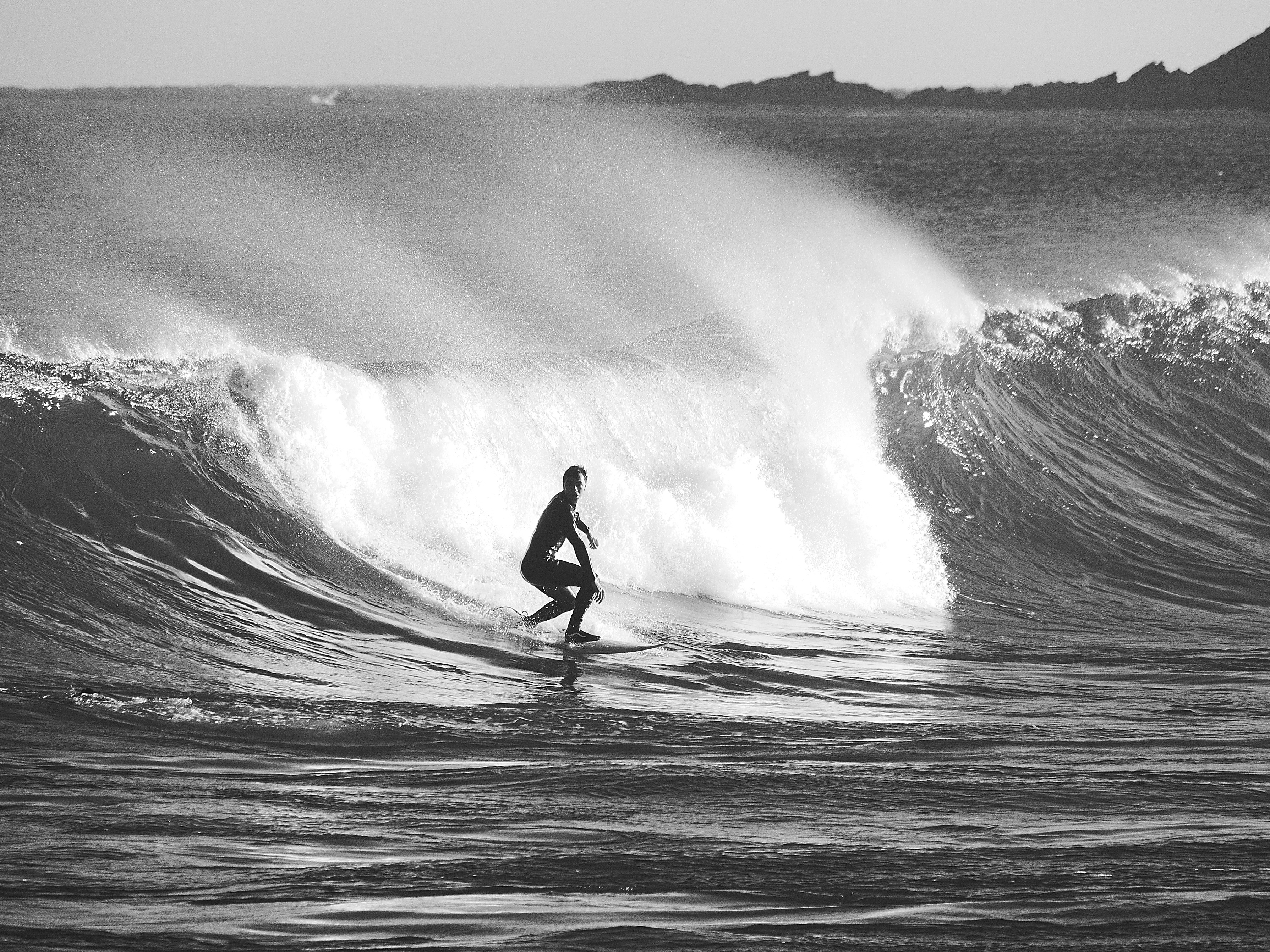 A man riding a wave on top of a surfboard photo – Free Nature Image on ...