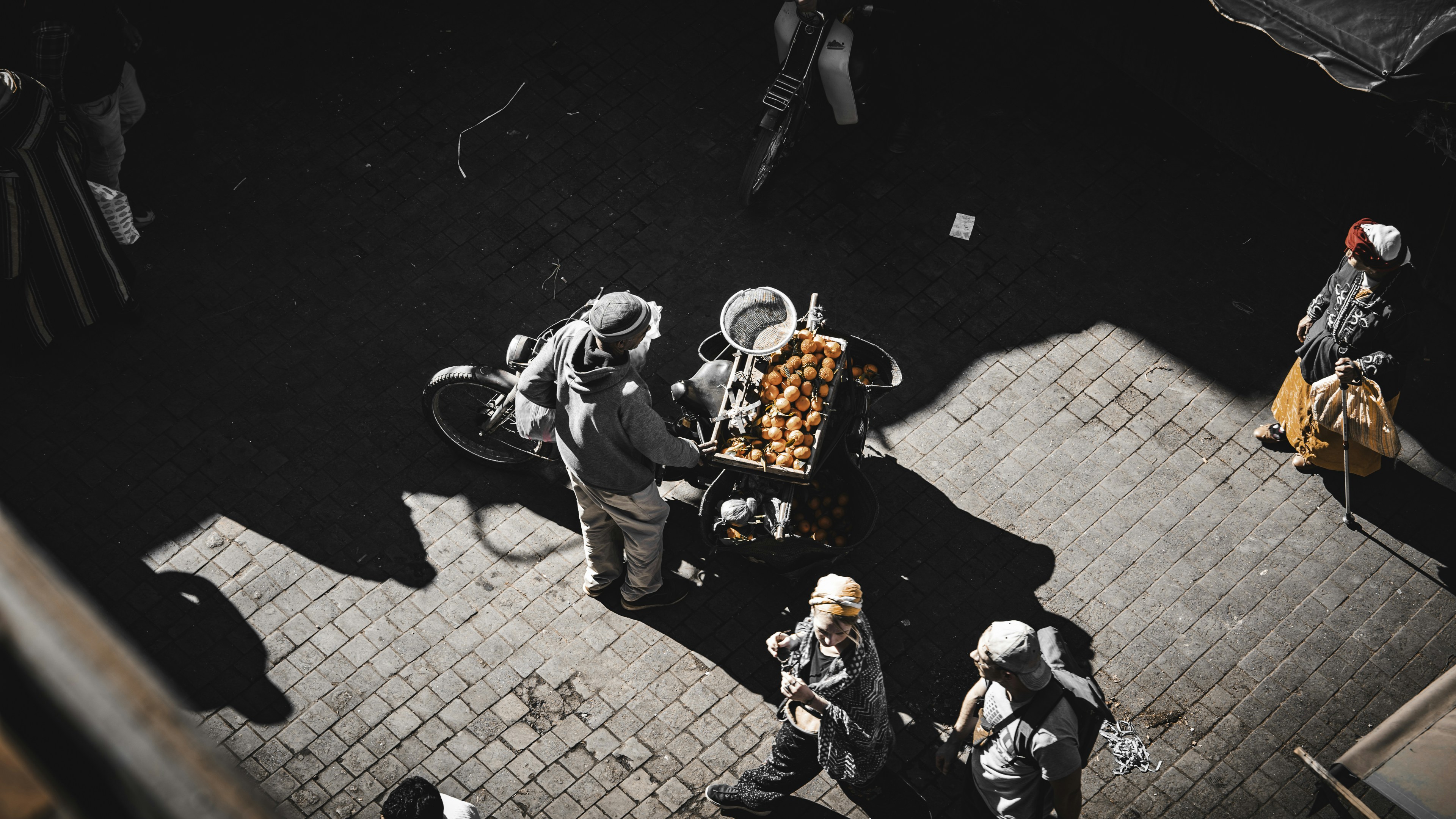 A group of people walking down a street next to each other