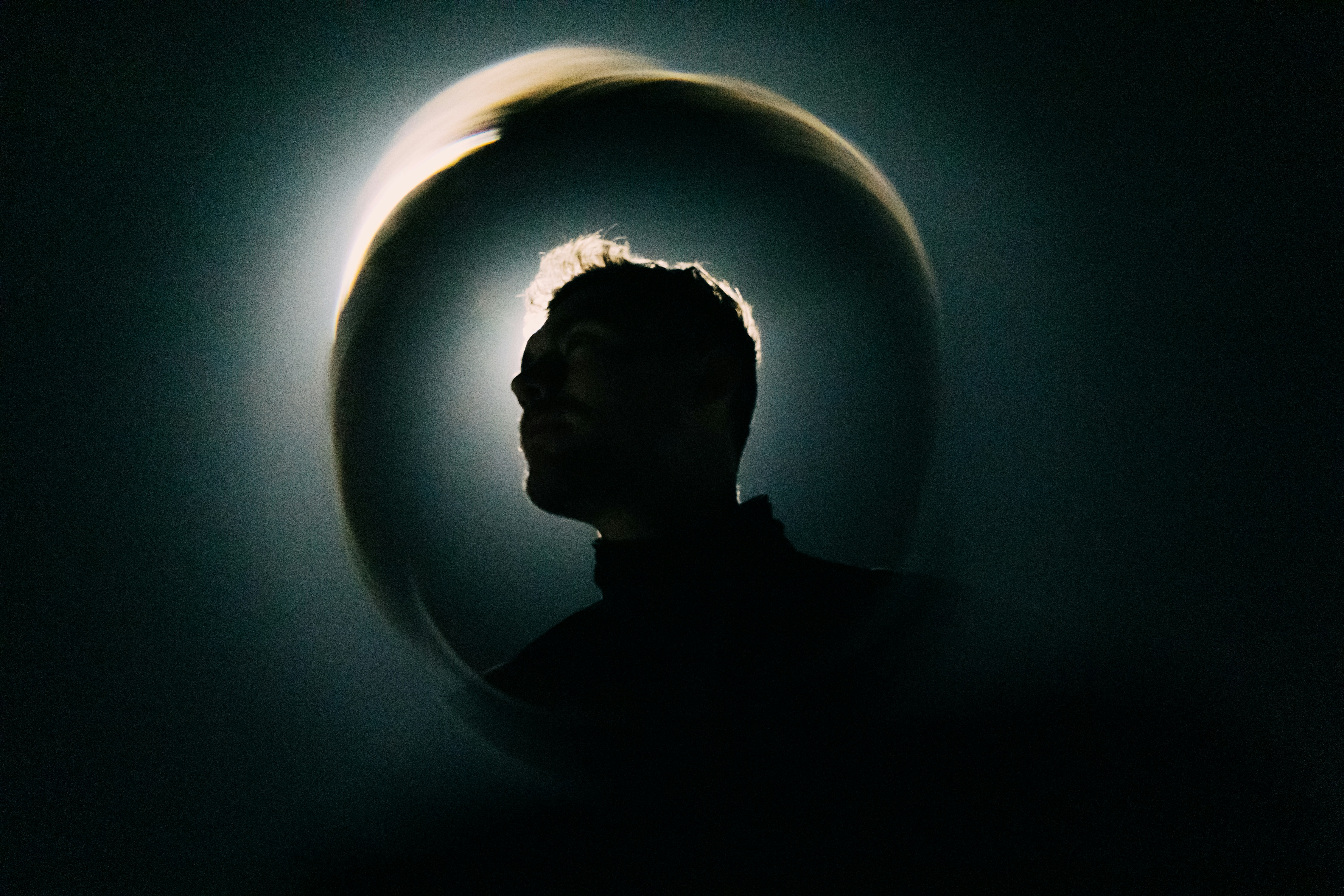 A man standing in front of a circular object