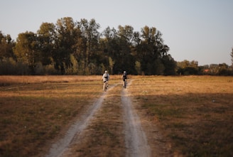 A couple of people that are standing in the grass