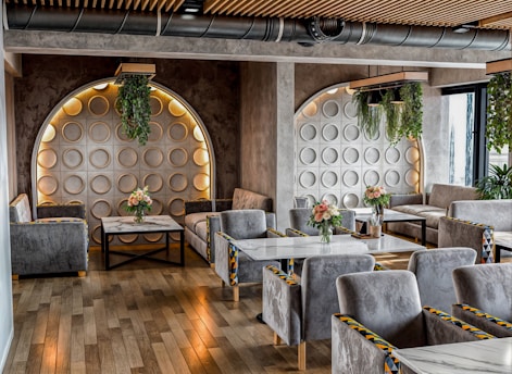 A restaurant with wooden floors and gray chairs