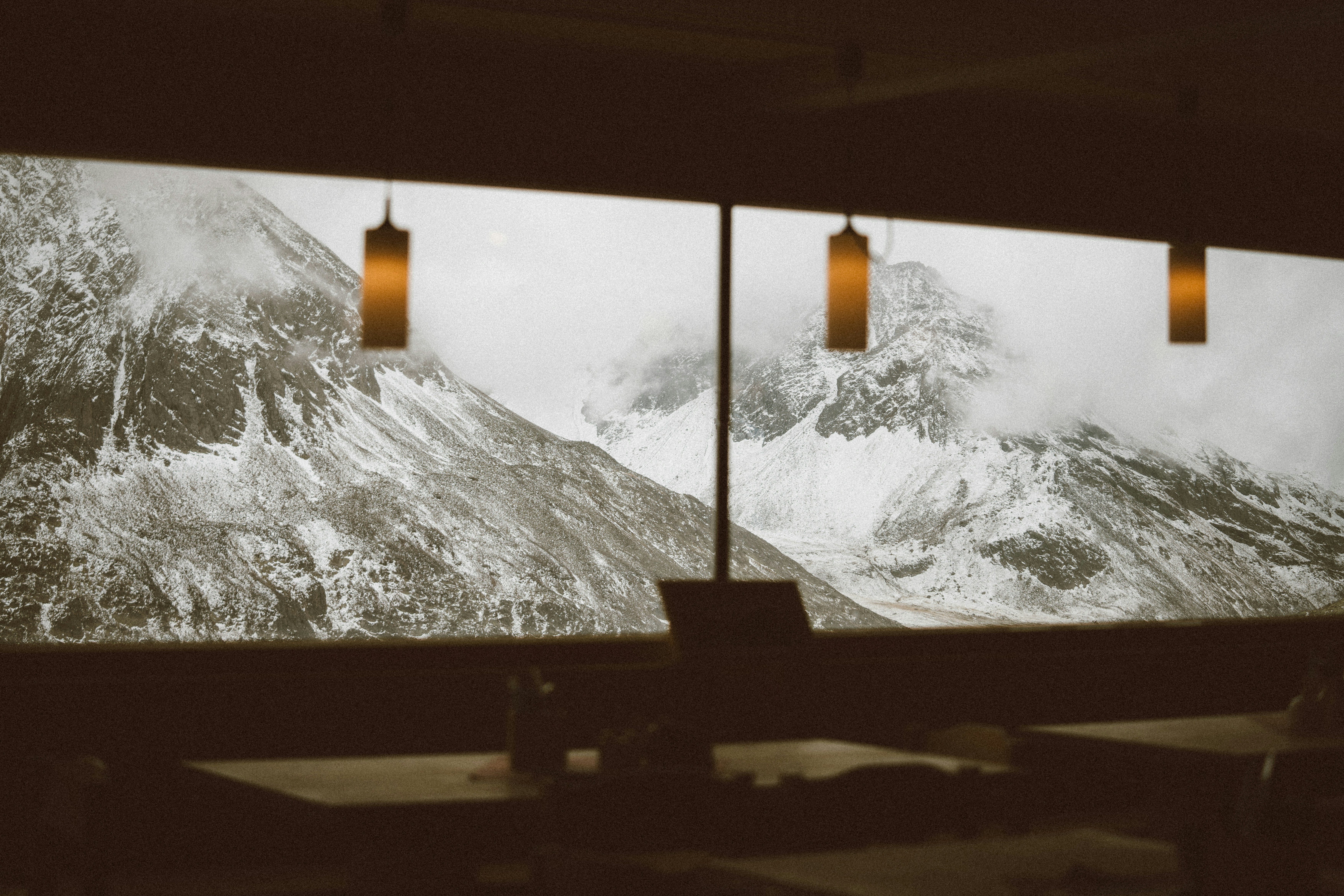 A couple of windows with mountains in the background