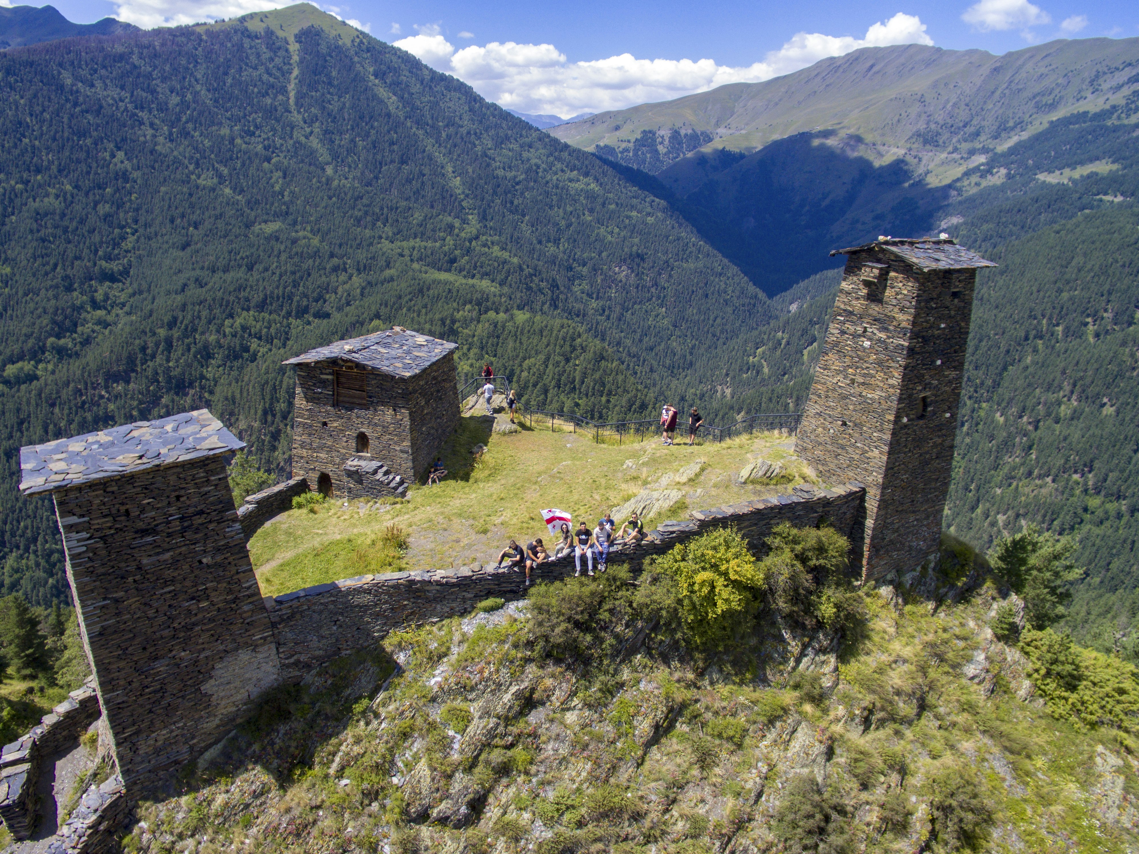 A group of people standing on top of a mountain