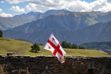 A flag flying on top of a stone wall