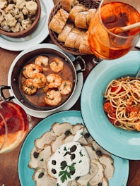 A table topped with plates of food and drinks