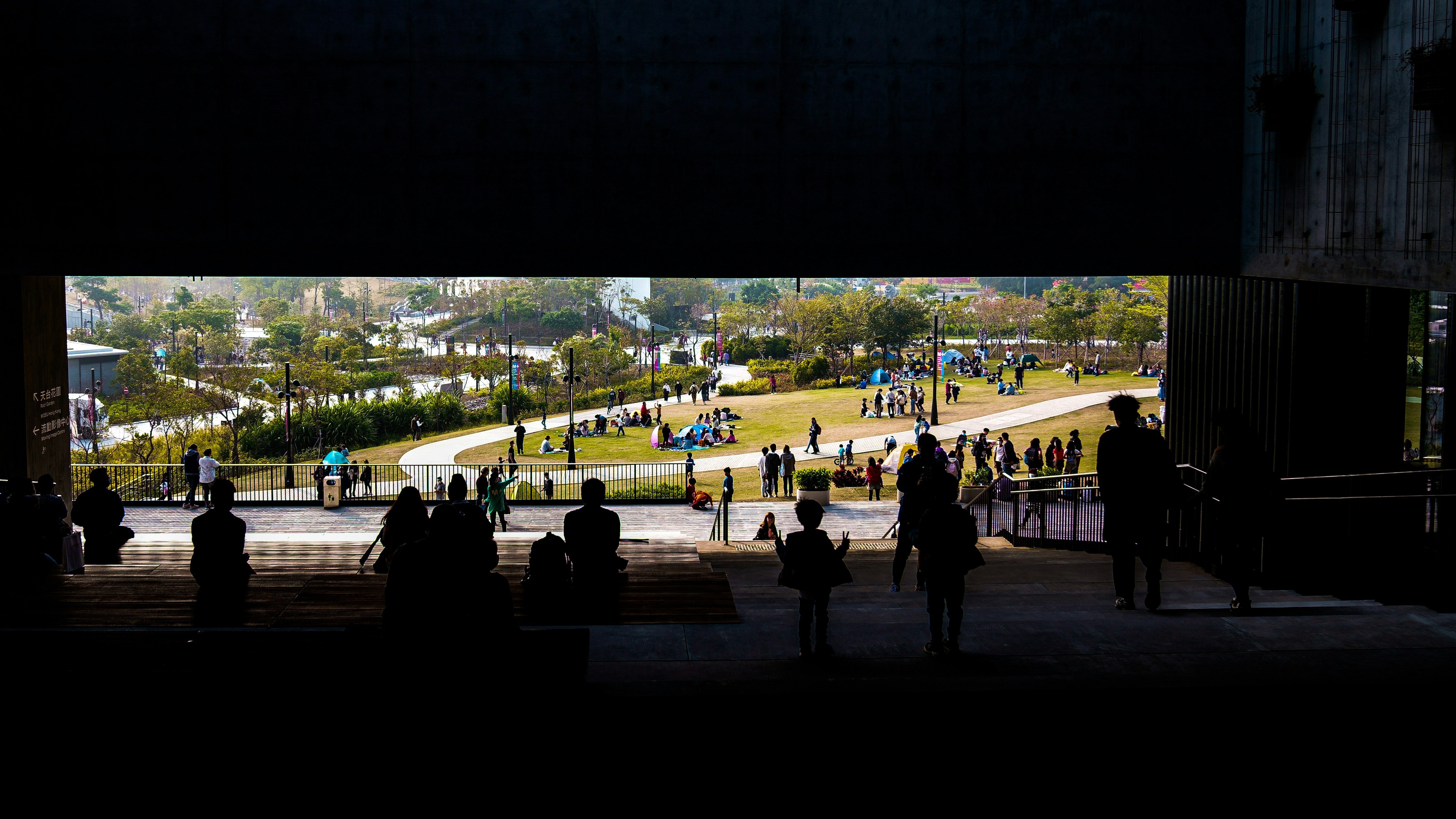A group of people standing under a bridge