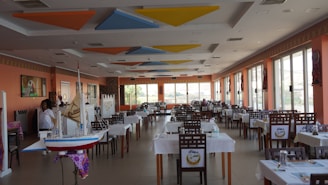 A large dining room with tables and chairs