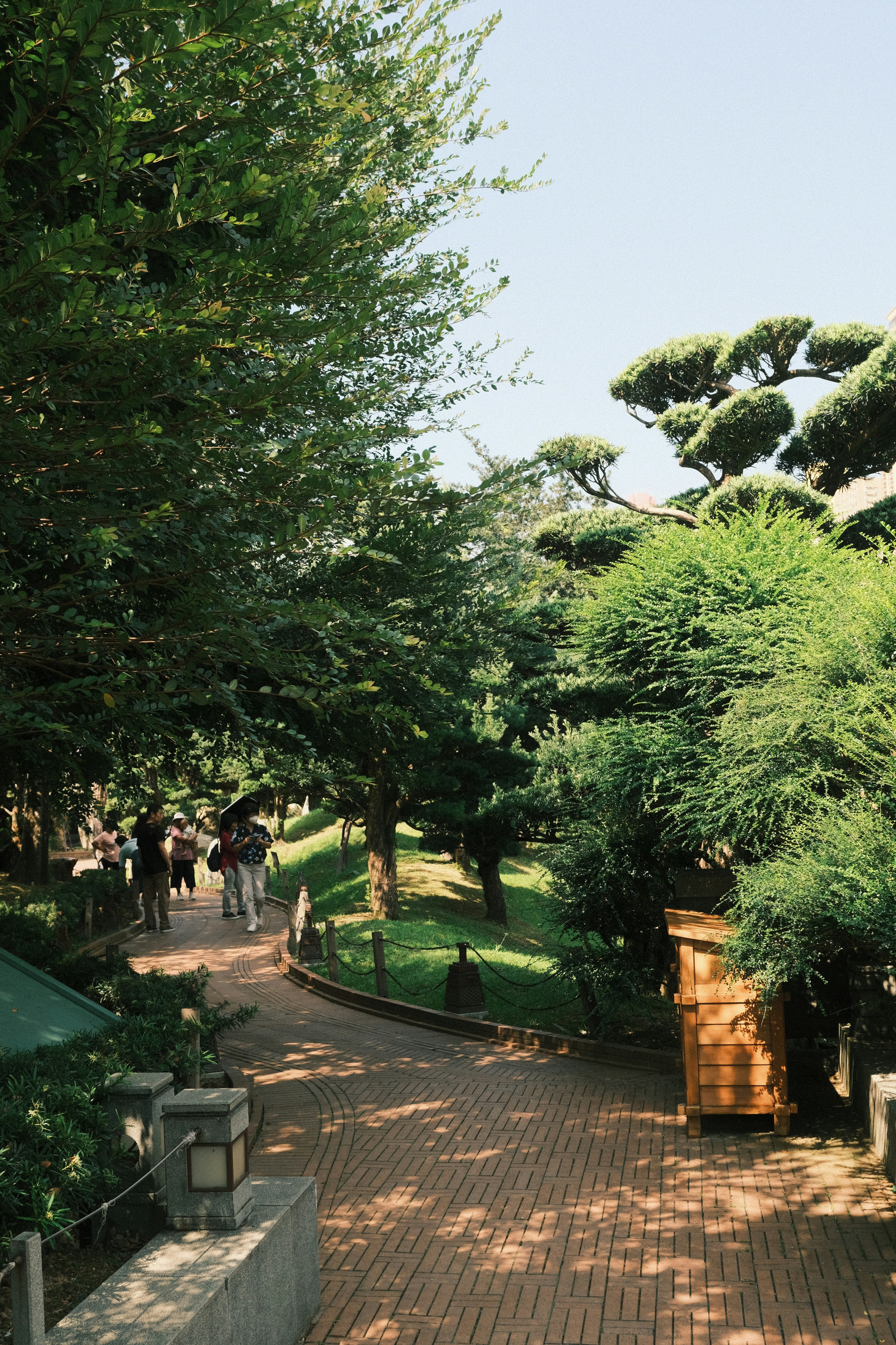 People walking down a path in a park