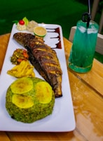 A plate of food on a table with a drink