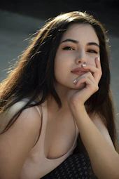 Aditya - A woman escort  with long brown hair sitting on a bench