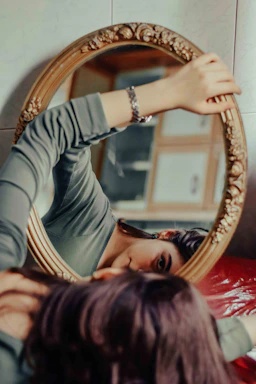 A woman looking at herself in a mirror