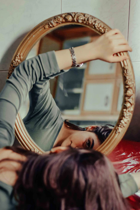 A woman looking at herself in a mirror
