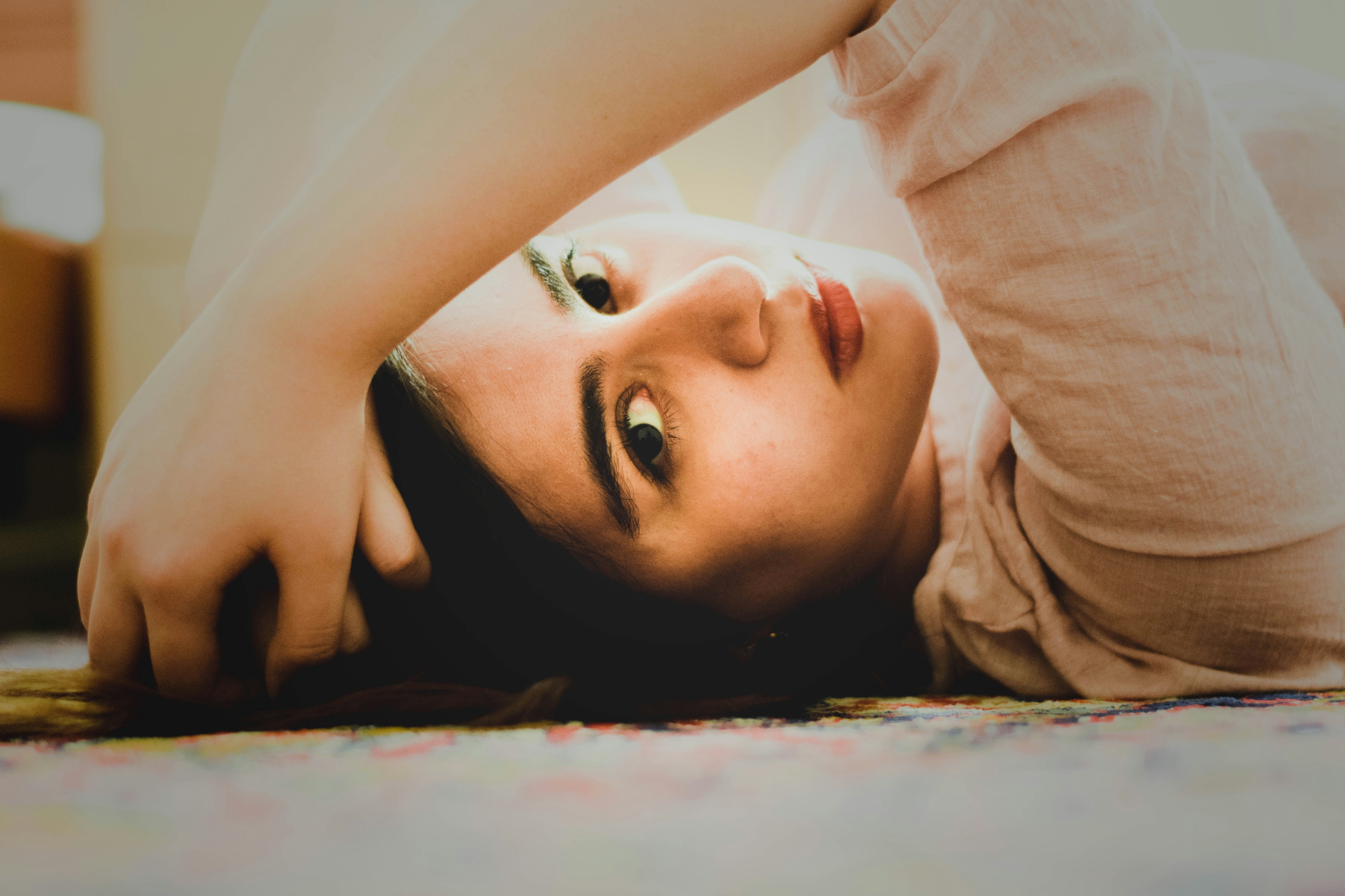 A woman laying on the floor with her head on her hands