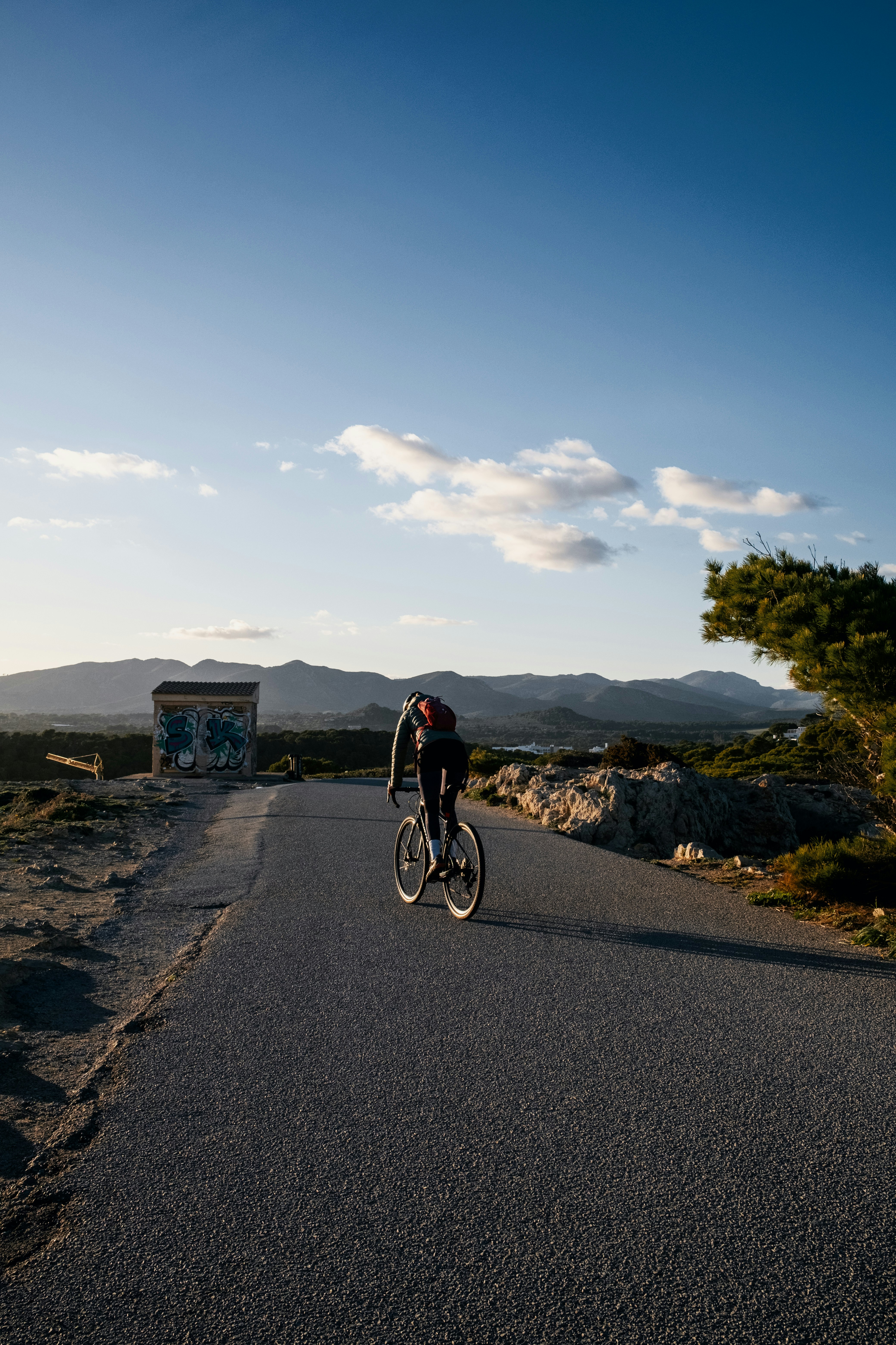 A person riding a bike down a road