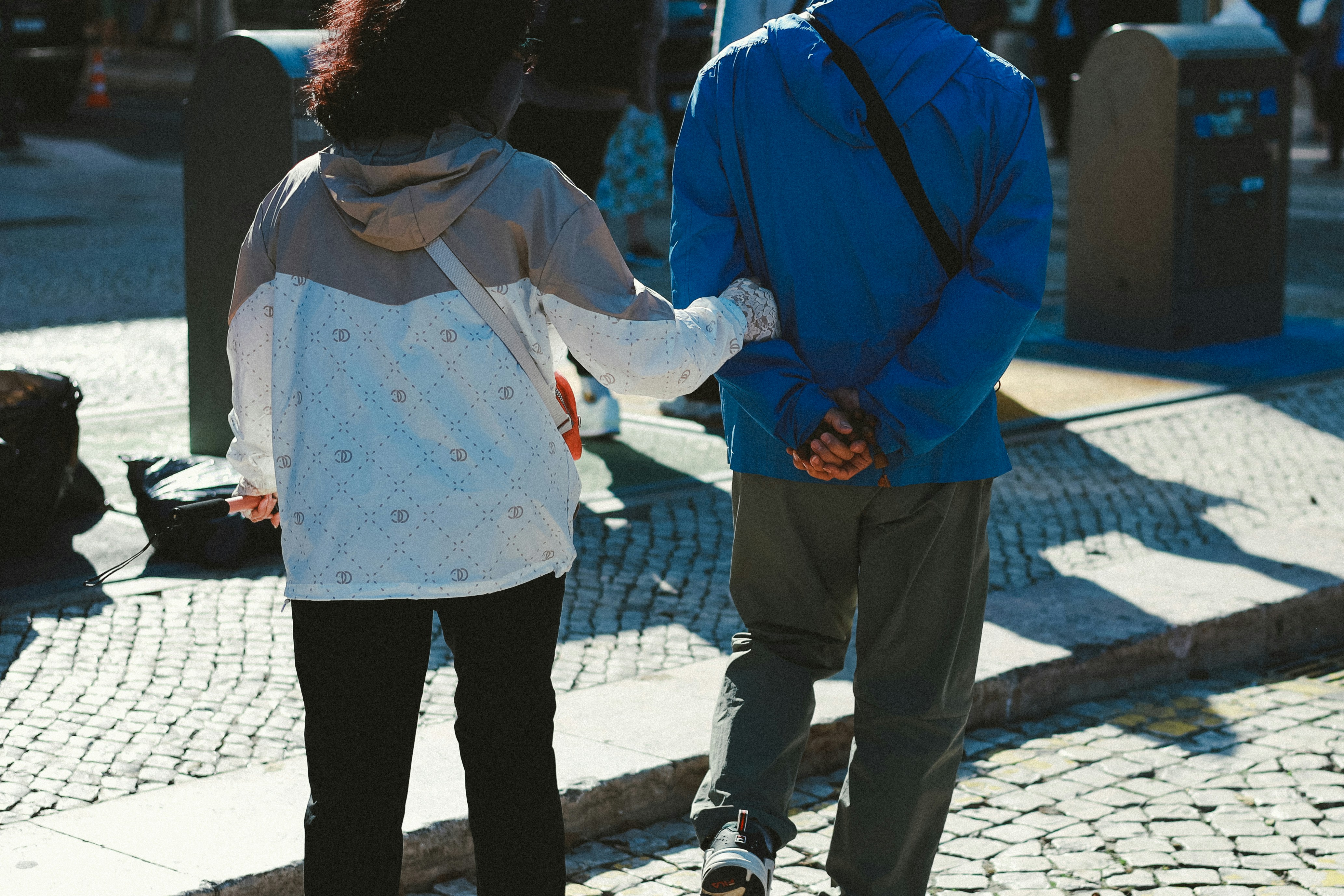 a parent and teen smiling and walking together outdoors - counselling teenagers