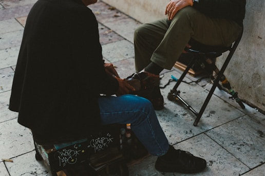 A man sitting on a chair next to a wall