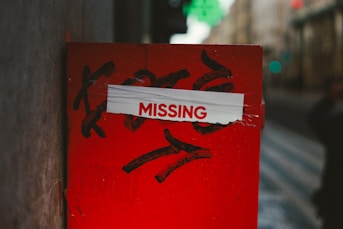A red post with a missing sign on it