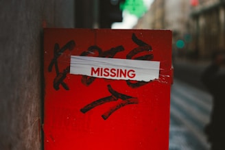 A red post with a missing sign on it