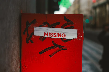 A red post with a missing sign on it
