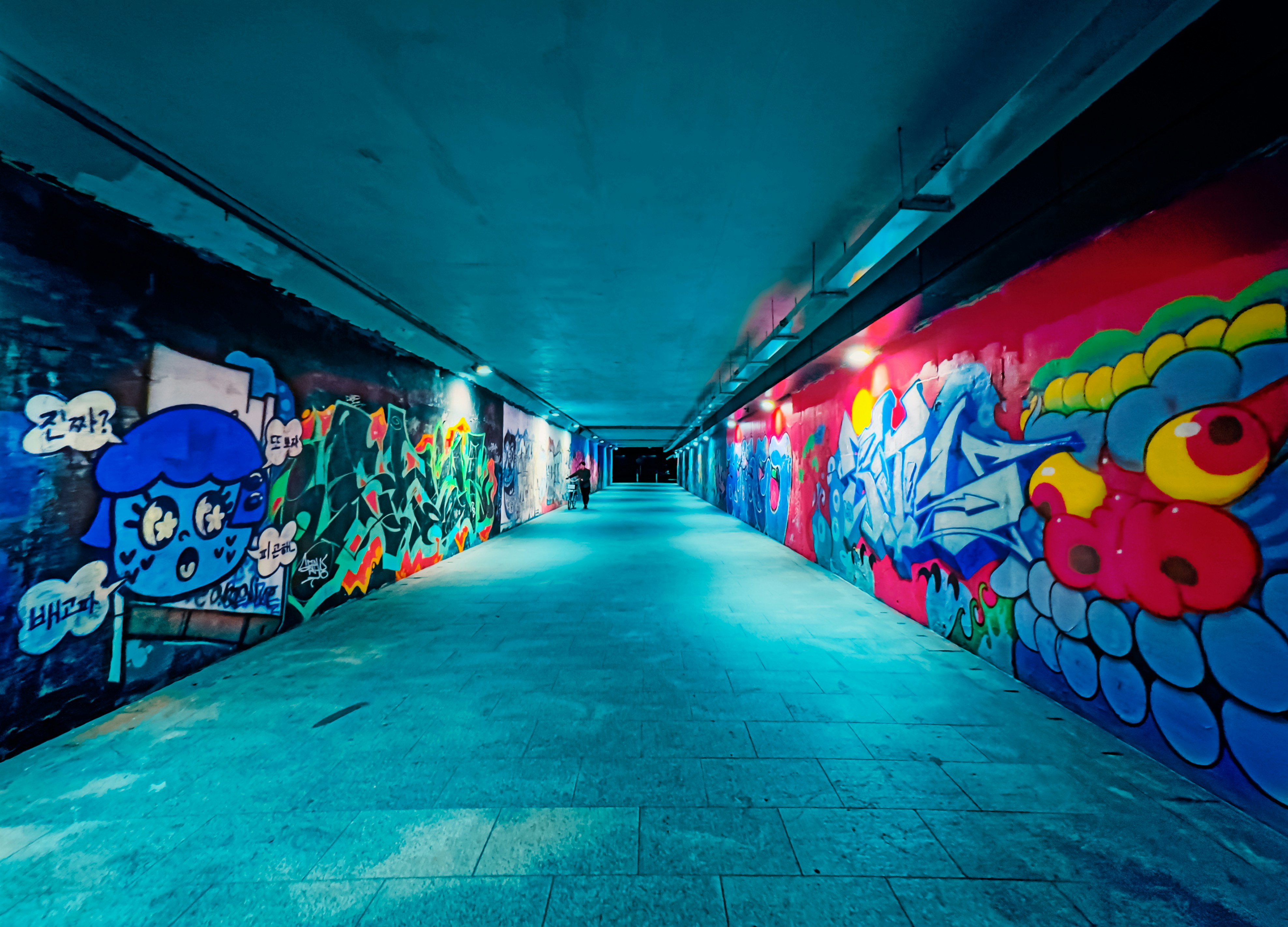 A long hallway with graffiti on the walls