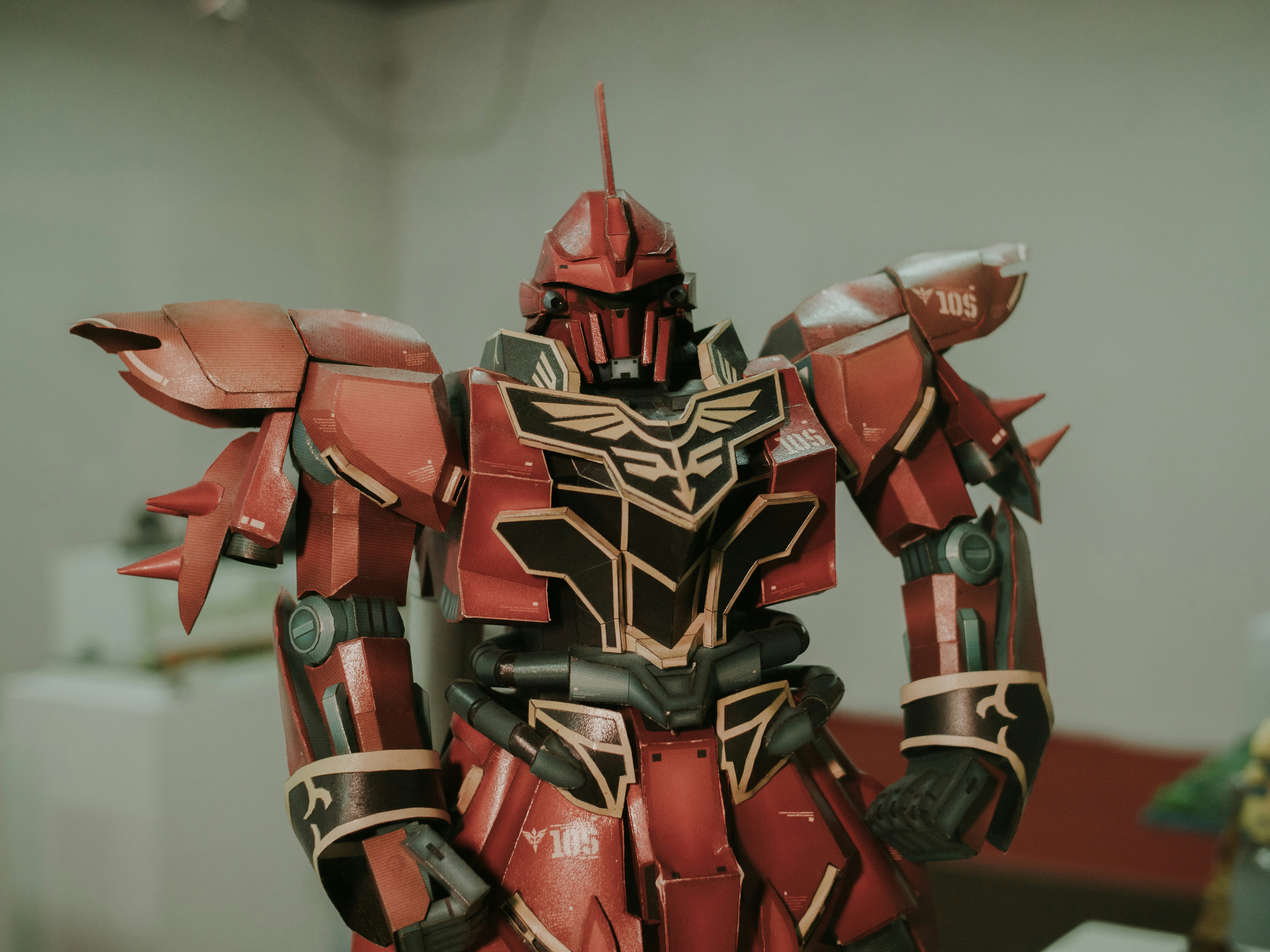 A red and black robot standing in a room