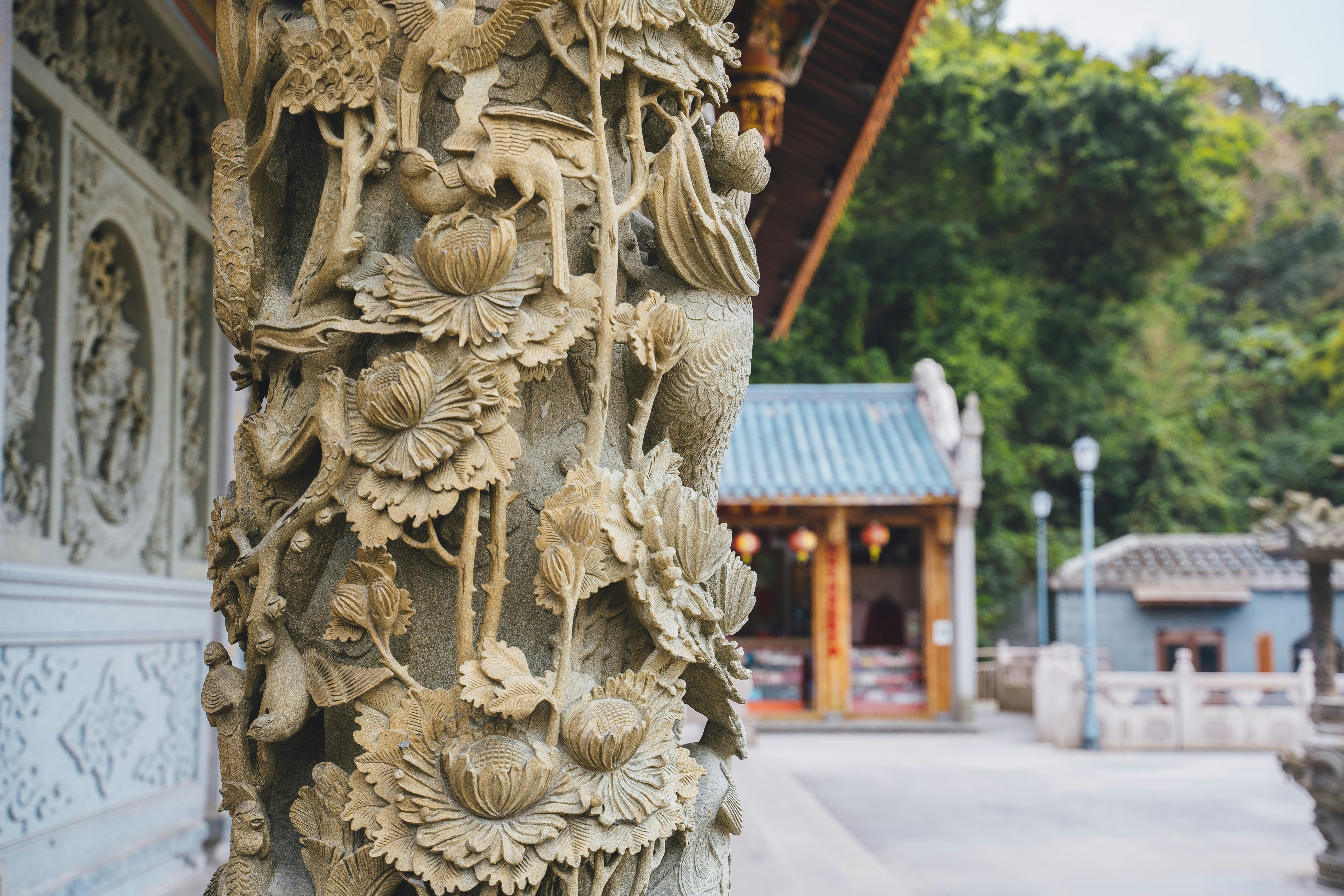 Close-up view of the stone pillar supporting the pagoda, with intricate carvings visible