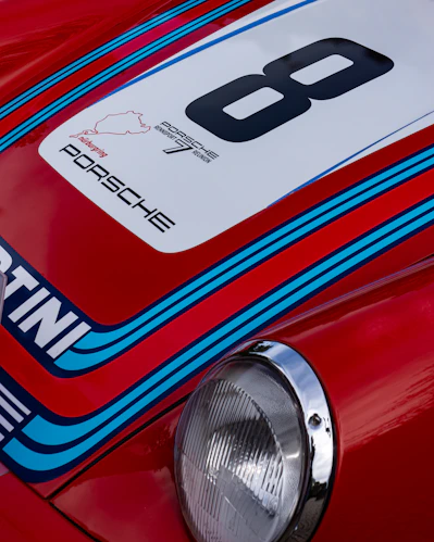 A close up of the front of a red sports car
