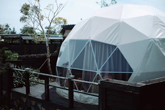 A large white dome sitting on top of a wooden platform