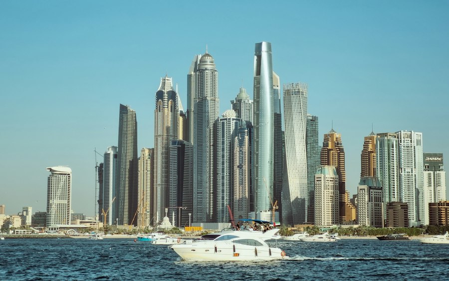 White yacht in front of the Dubai Marina skyline