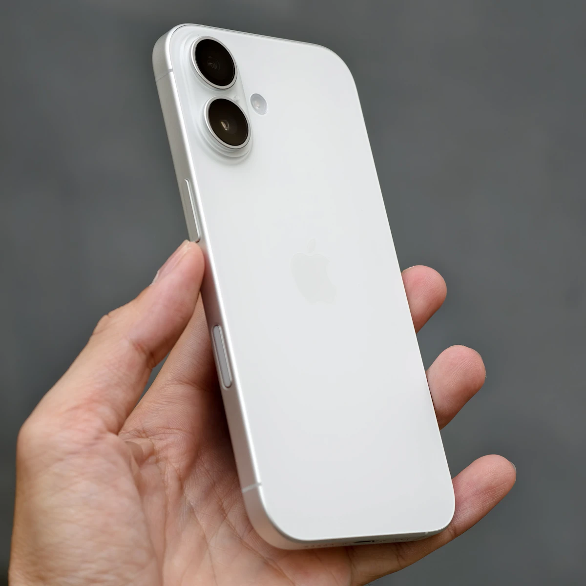 White iPhone 14 Plus in hand while testing Siri AI on iOS 27 Beta