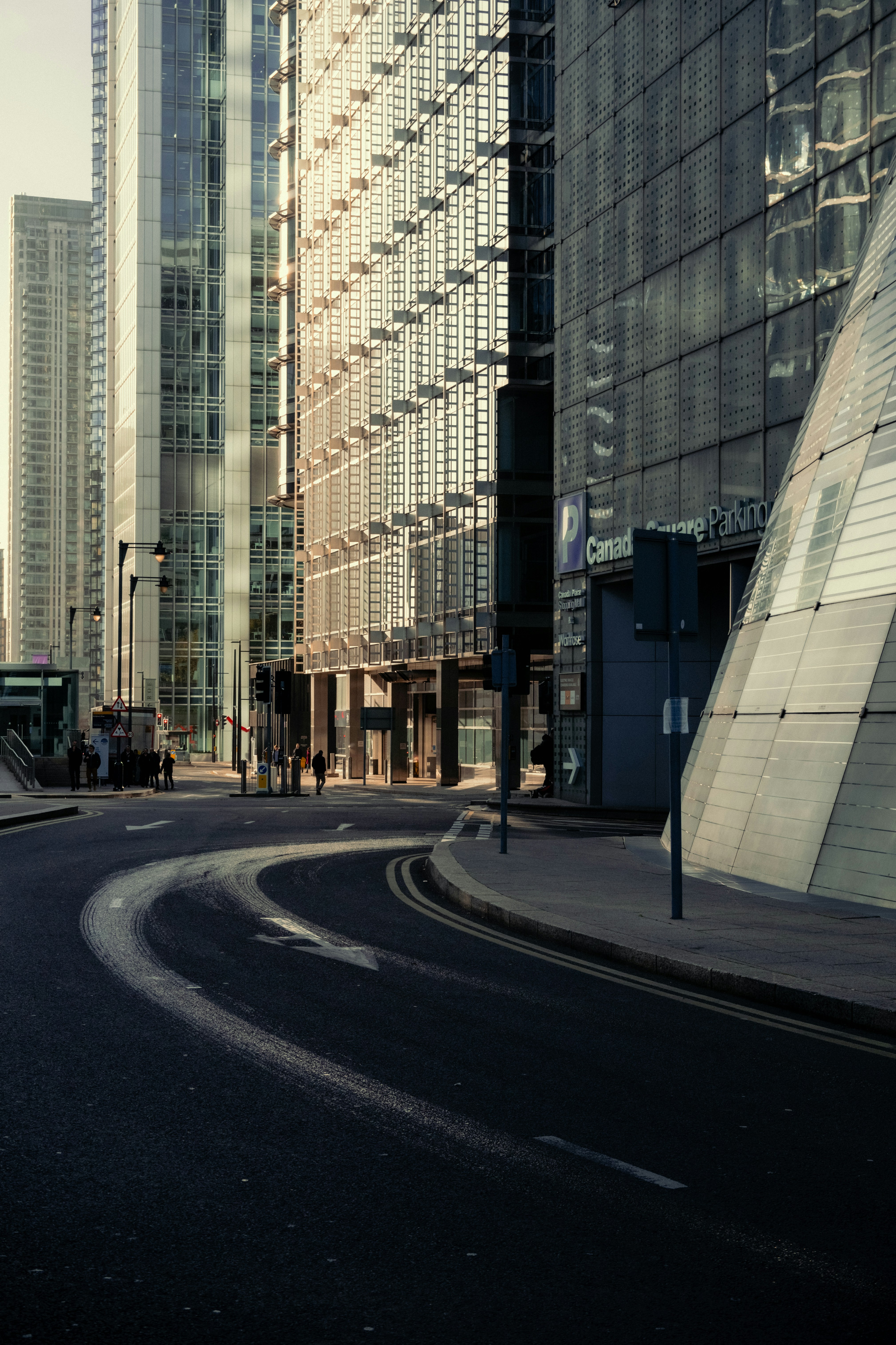 A curved road in a city with tall buildings