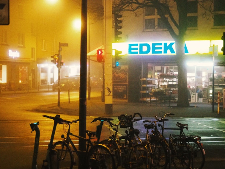 A group of bikes parked on the side of a street