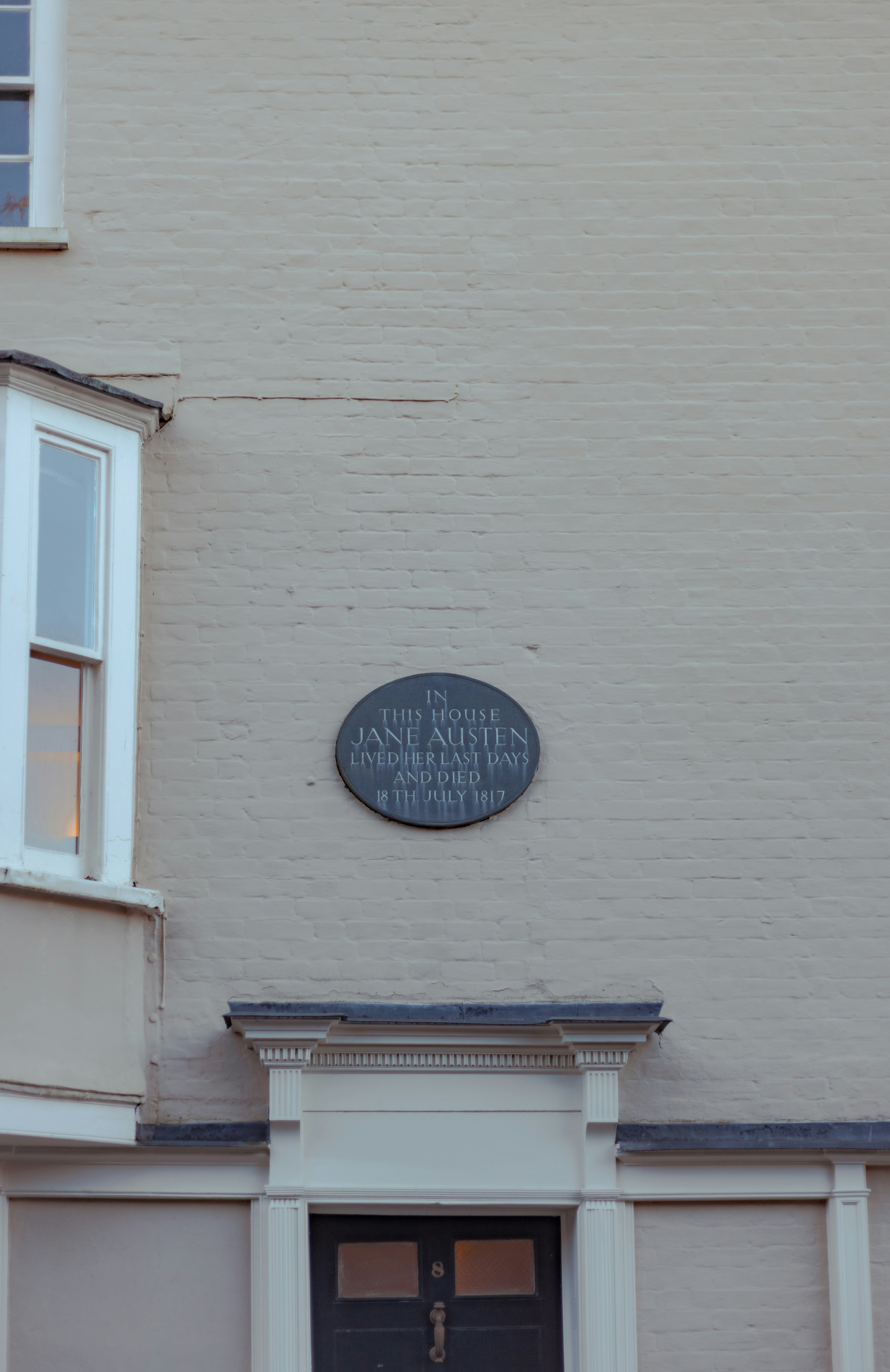 The front of a building with a plaque on it