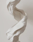A sculpture of a woman with flowing white fabric
