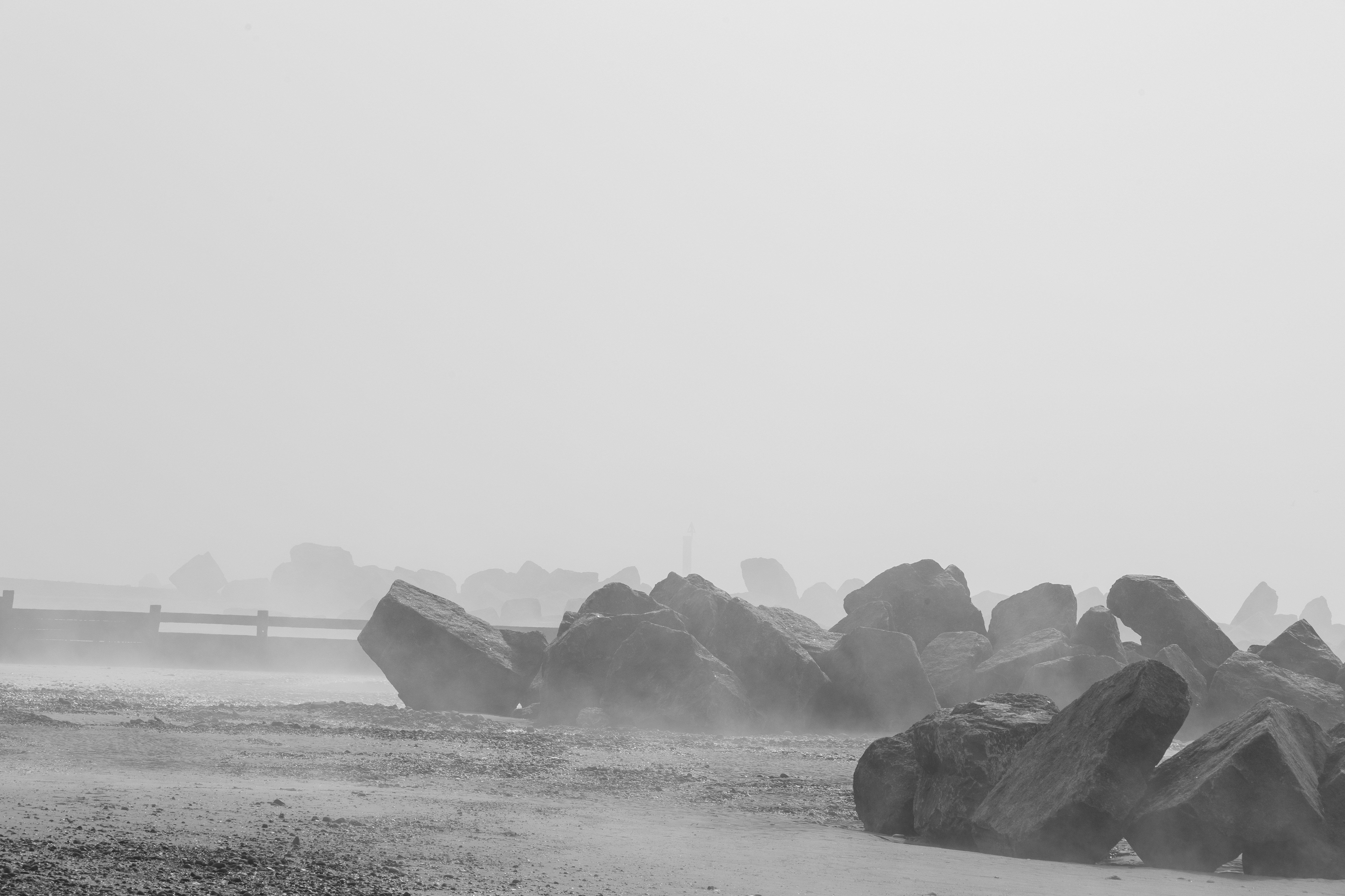 A black and white photo of rocks in a field