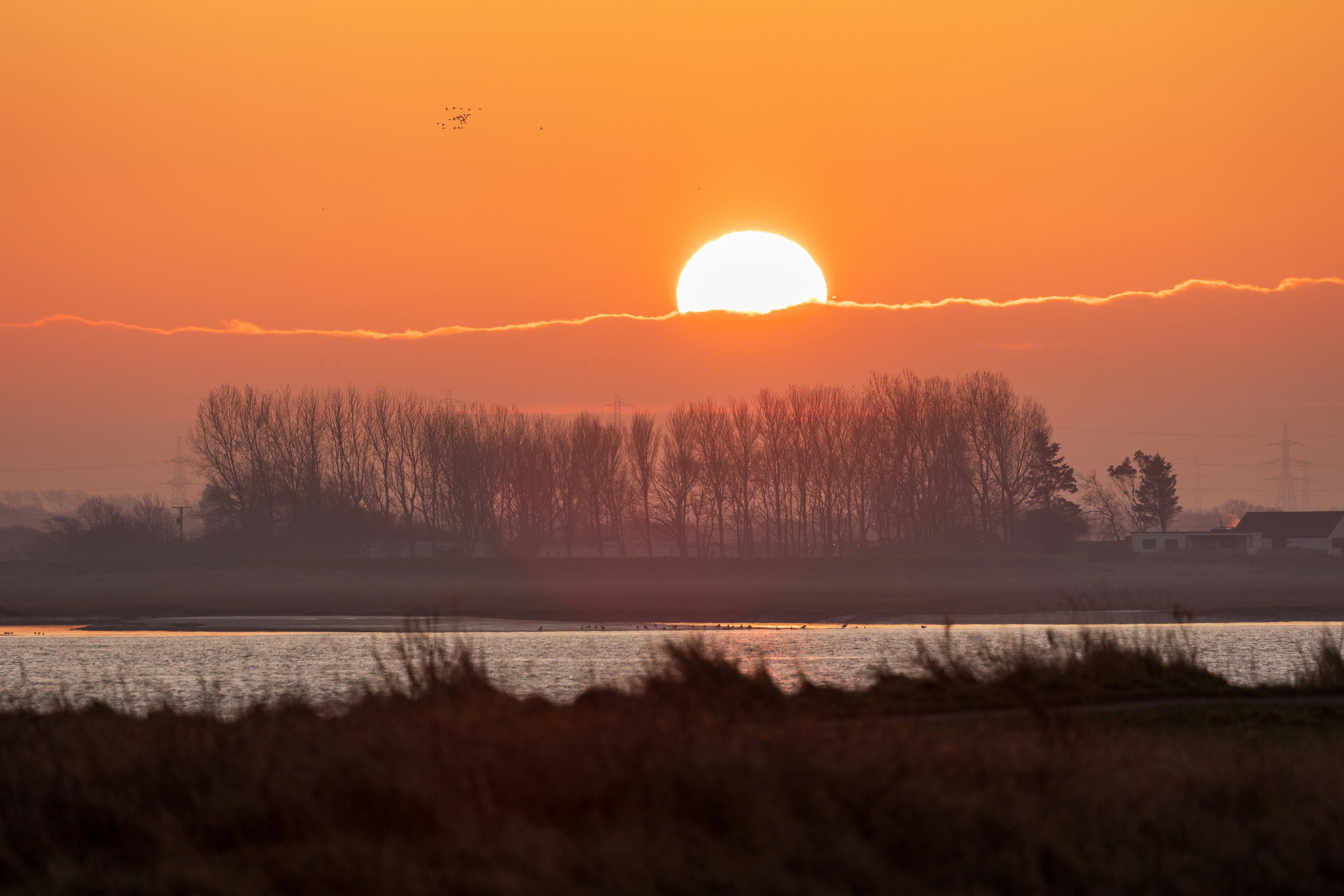 The sun is setting over a body of water
