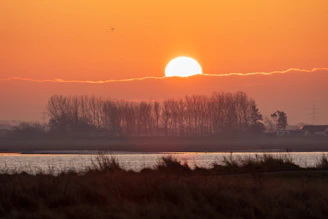 The sun is setting over a body of water