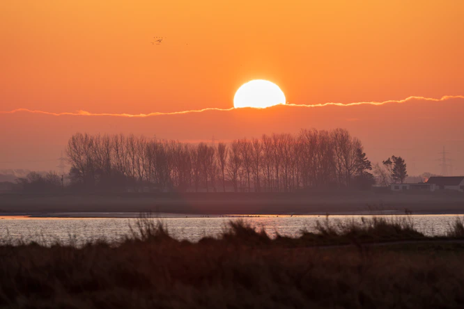The sun is setting over a body of water