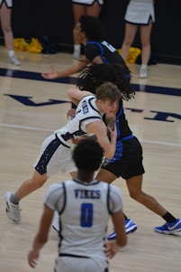 A group of young men playing a game of basketball