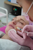 A woman getting her teeth checked by a dentist