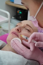 A woman getting her teeth checked by a dentist